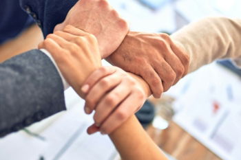 person in black long sleeve shirt holding persons hand